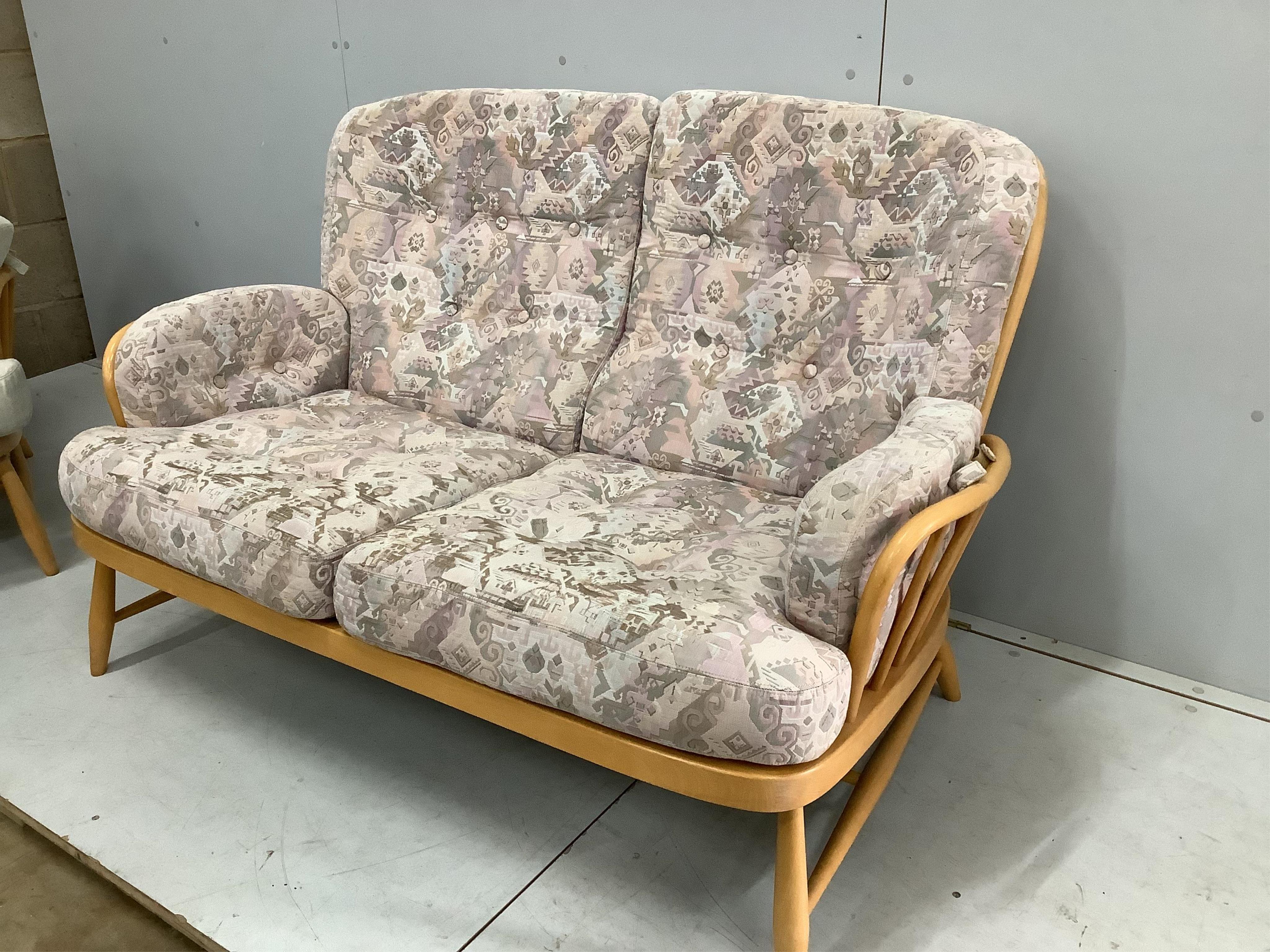 A pair of Ercol beech settees, width 140cm, depth 80cm, height 82cm